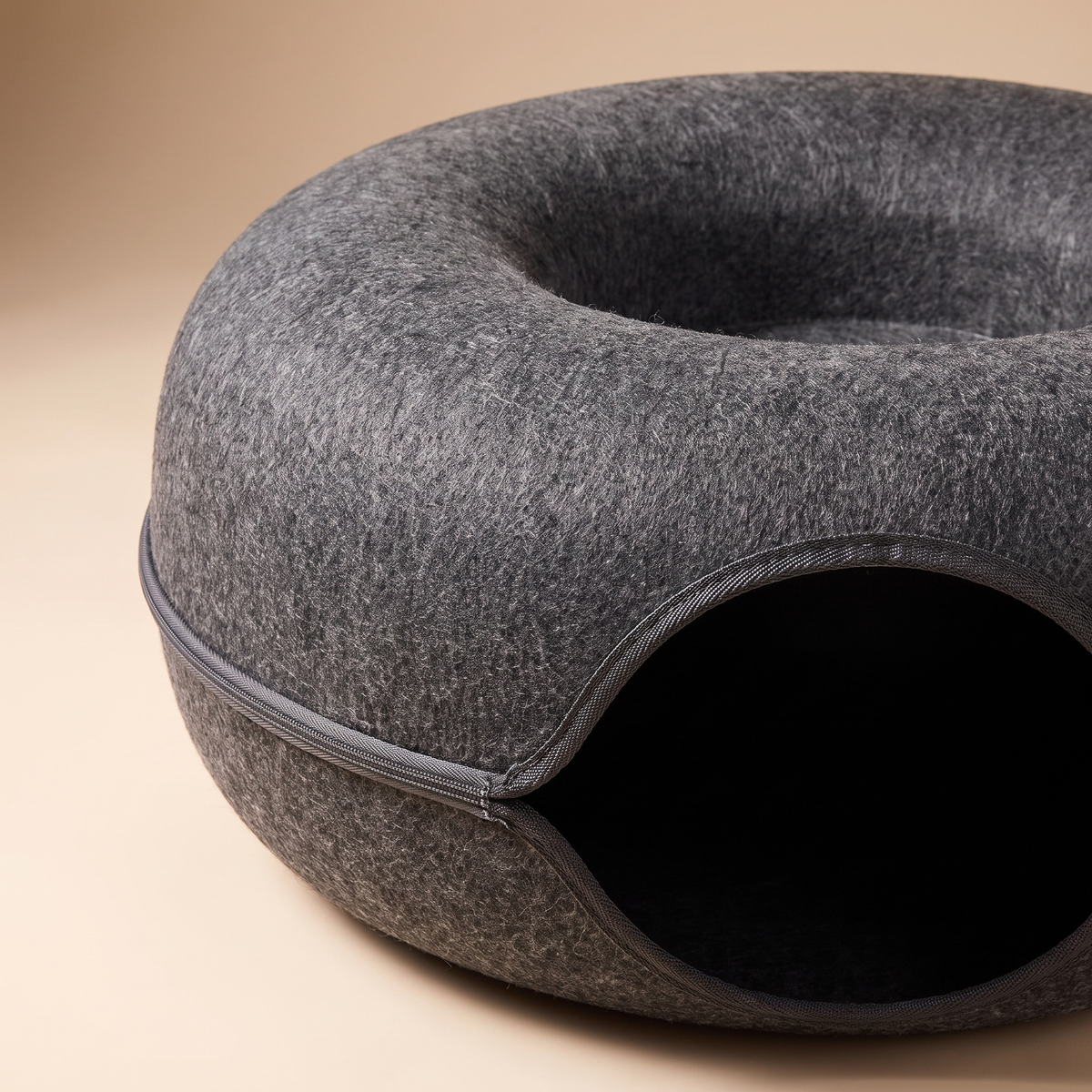 Close detail of the pressed felt texture and rolled rim of the donut bed