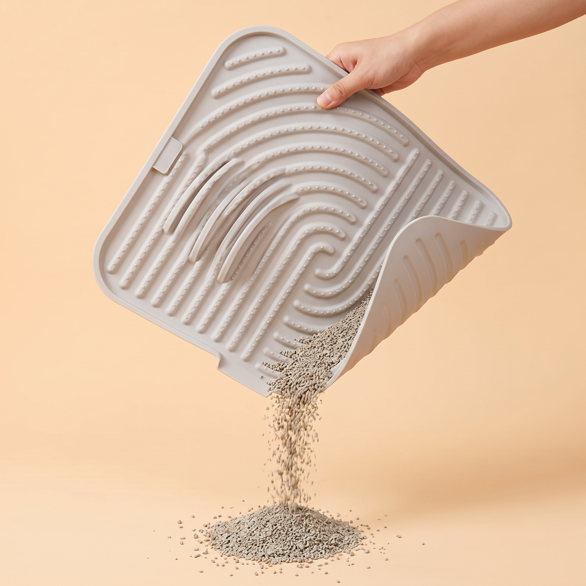 The silicone mat folded at one corner to pour out collected litter