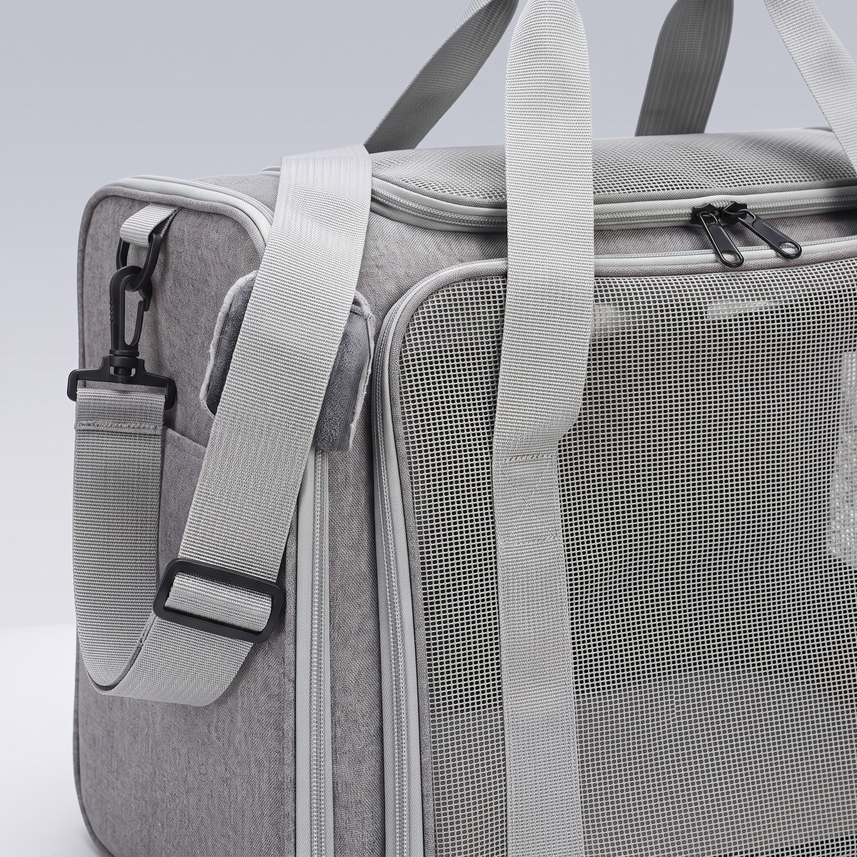 Close detail of the carrier mesh window and padded shoulder strap