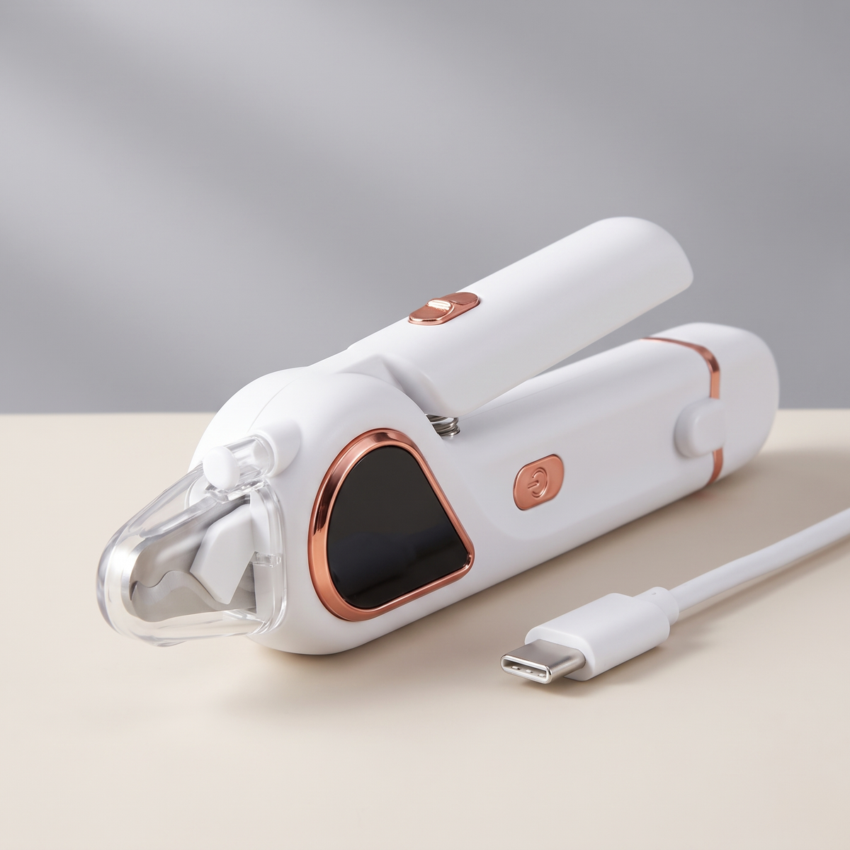 Close product view of the electric nail clipper with its Type-C charging cable