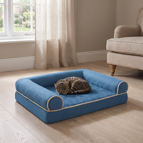 Cat curled asleep in the square bolstered pet bed on a wooden floor