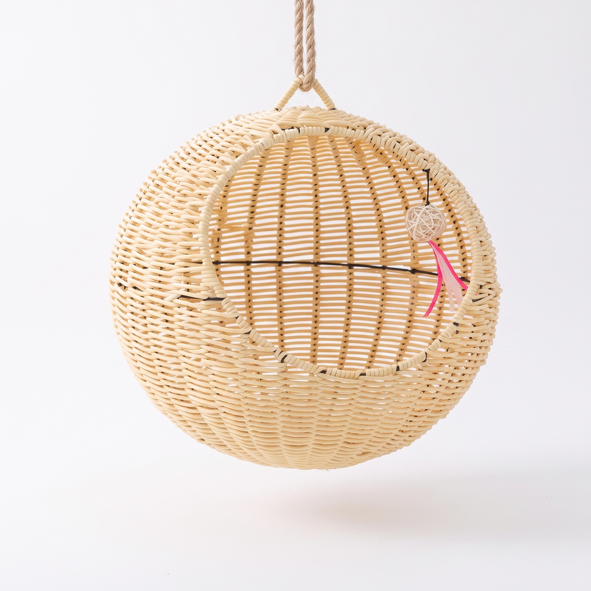 Rattan hanging cat basket on a white studio background