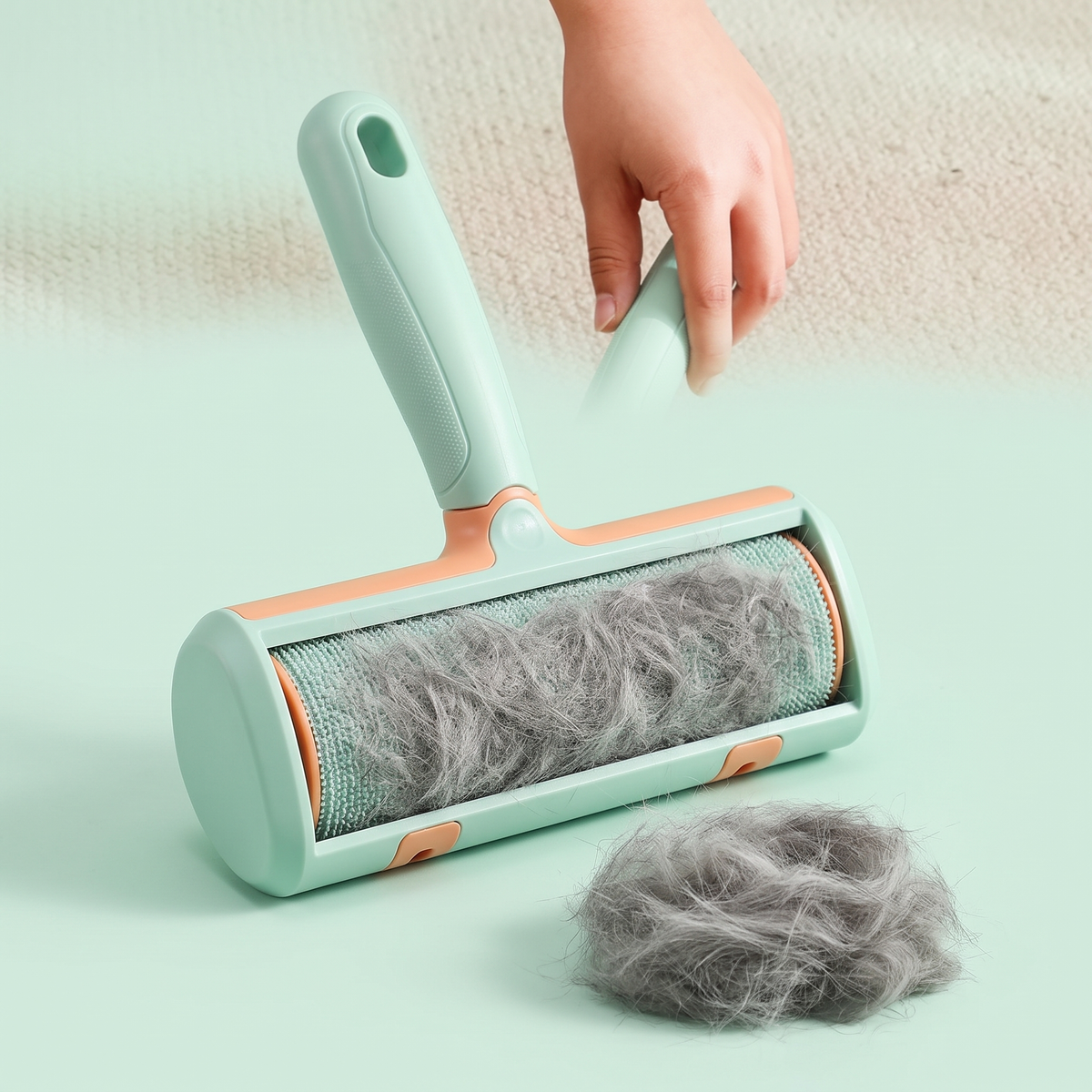 The brush face loaded with collected cat hair beside a gathered pile