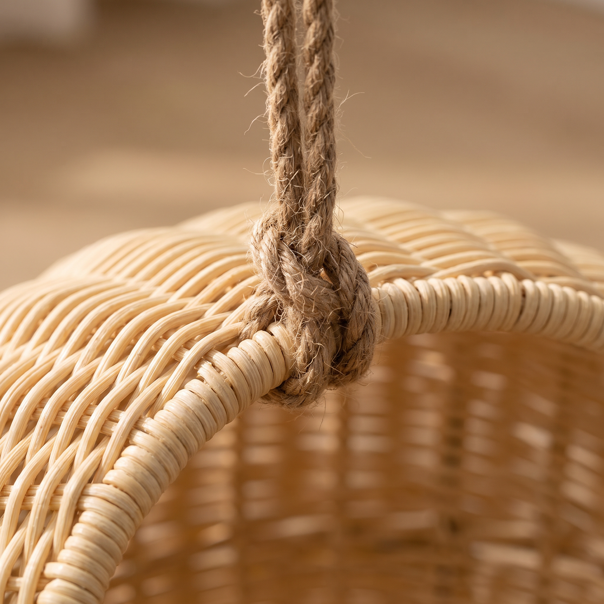 Close view of the hanging rope knot against the woven rattan rim