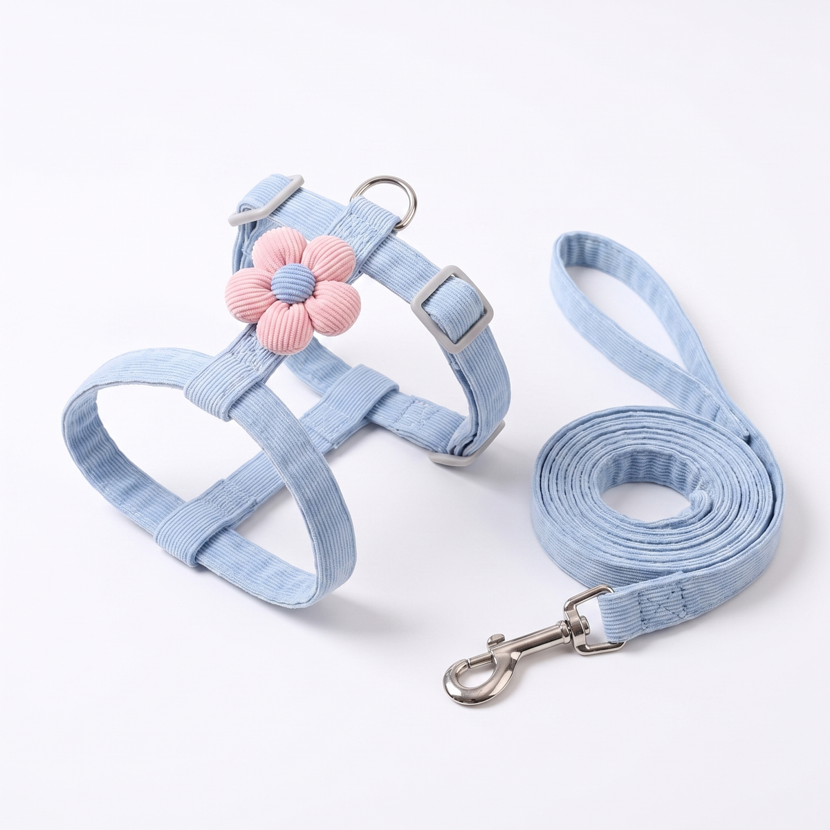 Cat harness and lead laid flat on a white studio background