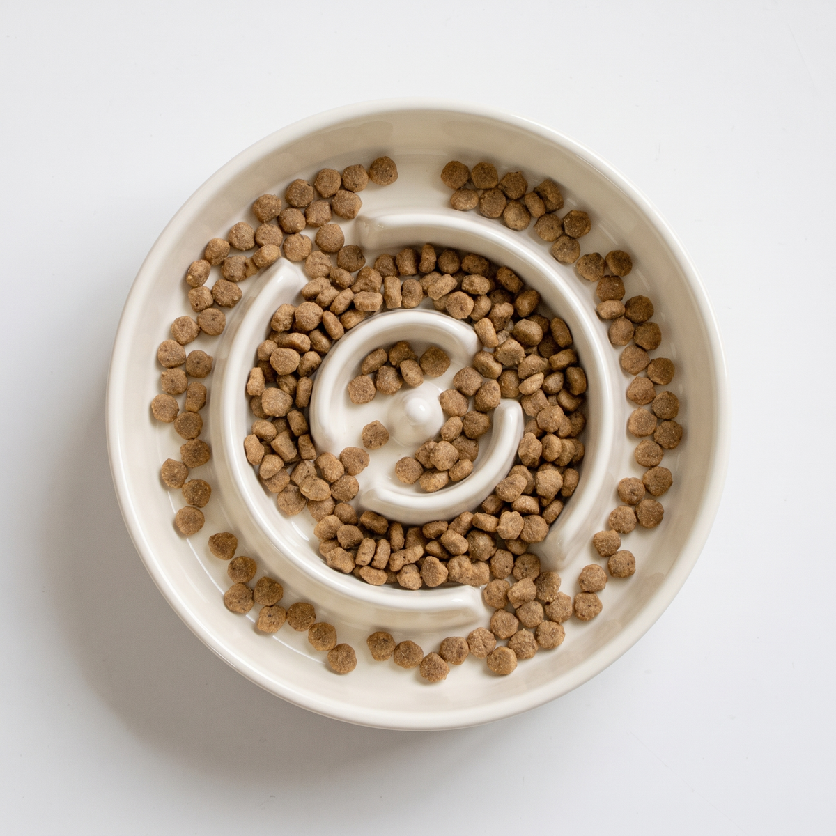 Overhead view of kibble caught between the slow feeder ridges