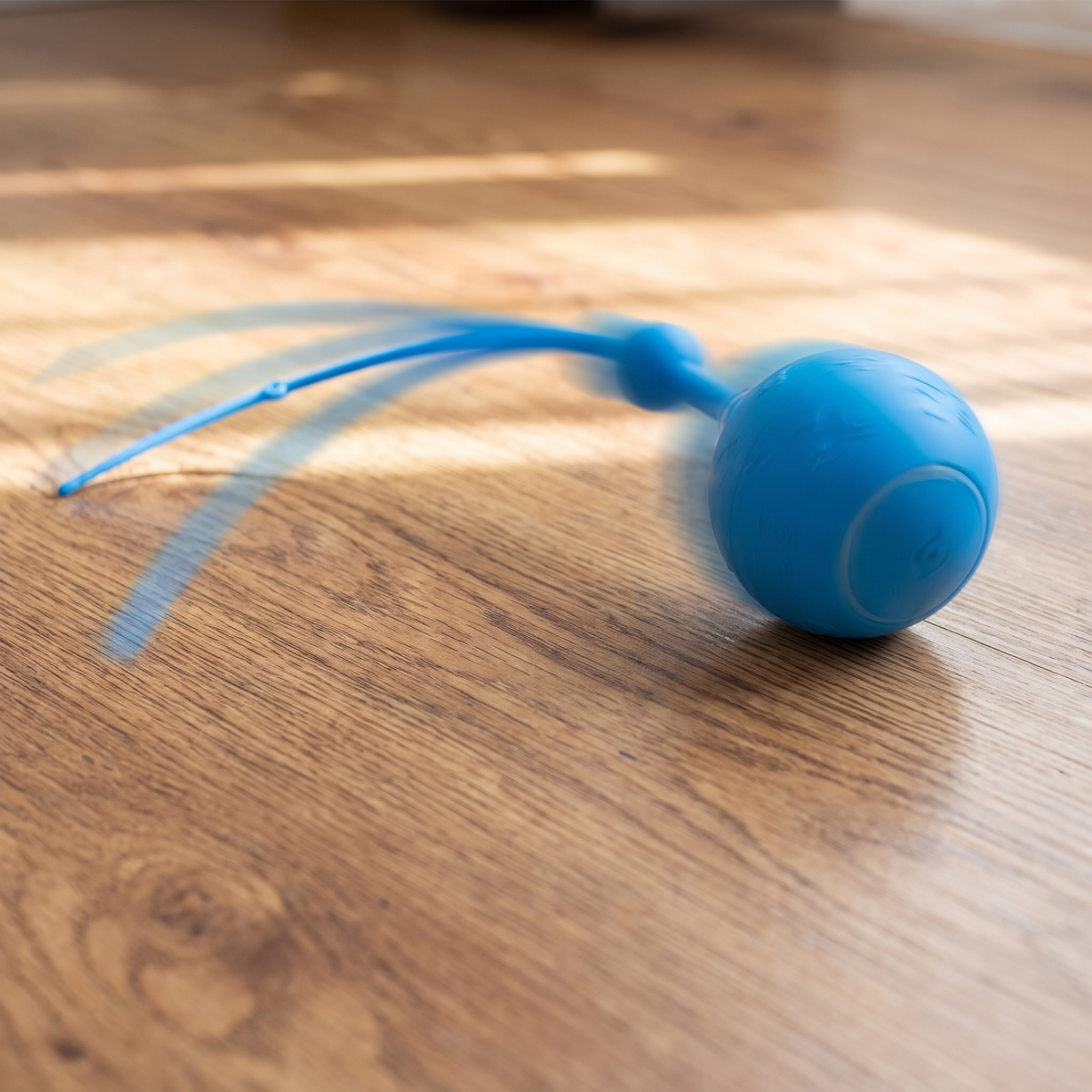 The toy in motion with the silicone tail trailing behind it
